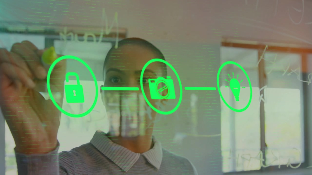 woman sketching with yellow marker on clear glass board in office with floating neon tech icons