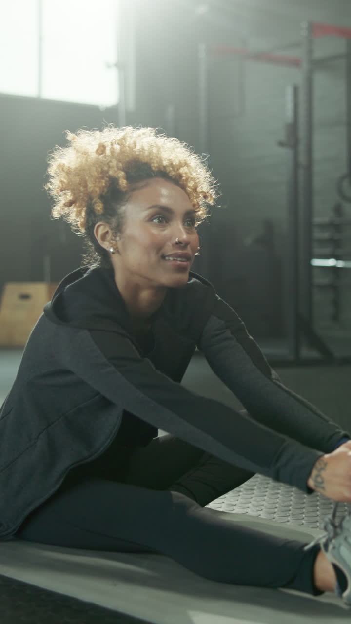 Happy Woman Stretching and Smiling During Gym Workout