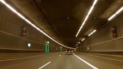 Following-a-car-in-several-tunnels-by-a-camera-view-from-the-front-engine-hood-in-Munich,-germany