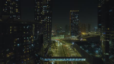 city vehicular traffic on bilshu'oum street looking from al reem island into abu dhabi, united arab emirates - elevate time lapse on a hot and steamy night