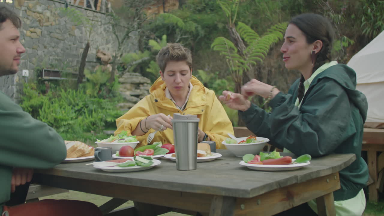 Friends Eating Dinner and Talking at Glampsite