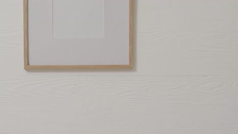 wooden frame with copy space with white background and white wall