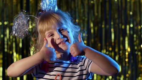 Futuristic-hipster-teen-girl-showing-thumbs-up-in-slow-motion-at-disco-party-club-in-blue-neon-light