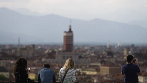 tourists looking over skyline of city turin in italy taking pictures