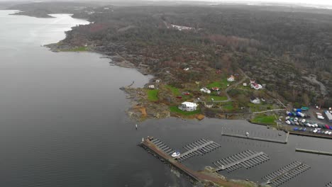 Aerial-flying-backwards-revealing-horizon-of-beautiful-coastal-landscape