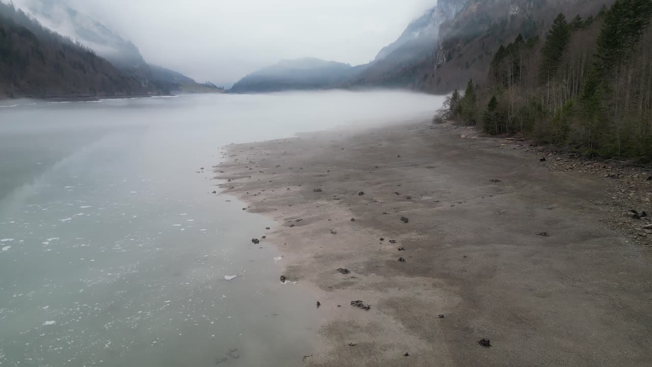 Klöntalersee Glarus Switzerland desolate beach along the misty lake