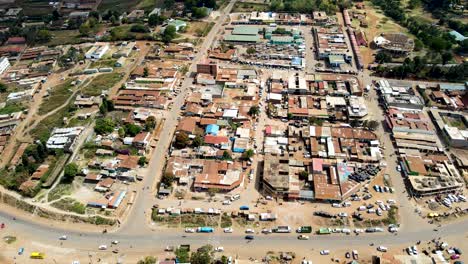 Aerial-flyover-poor-Kibera-Slum-and-modern-skyline-of-Nairobi-in-background-during-sunny-day