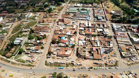 aerial flyover poor kibera slum and modern skyline of nairobi in background during sunny day
