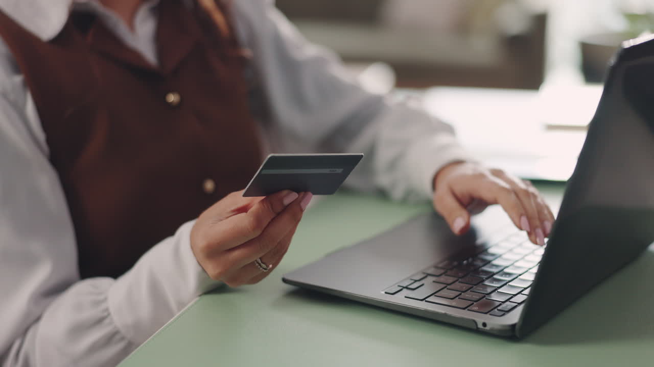 Woman shopping online with credit card at home