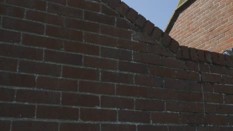 brick wall structure with st nicholas church tower in the background in harwich, essex england