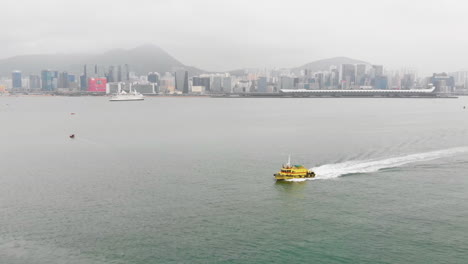 aerial footage of a yellow boat sailing on a canal