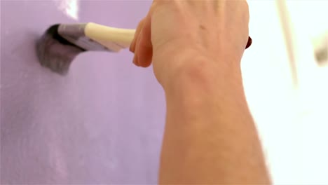 mujer redecorando una pared con un pincel