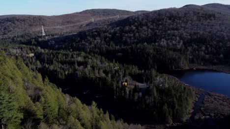 aerial reveal of north american forest landscape with electric wire towers