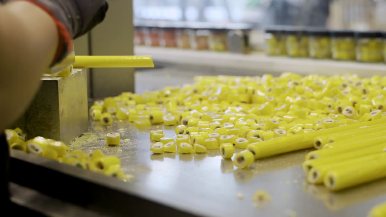 Making yellow pineapple caramel candies, slow motion