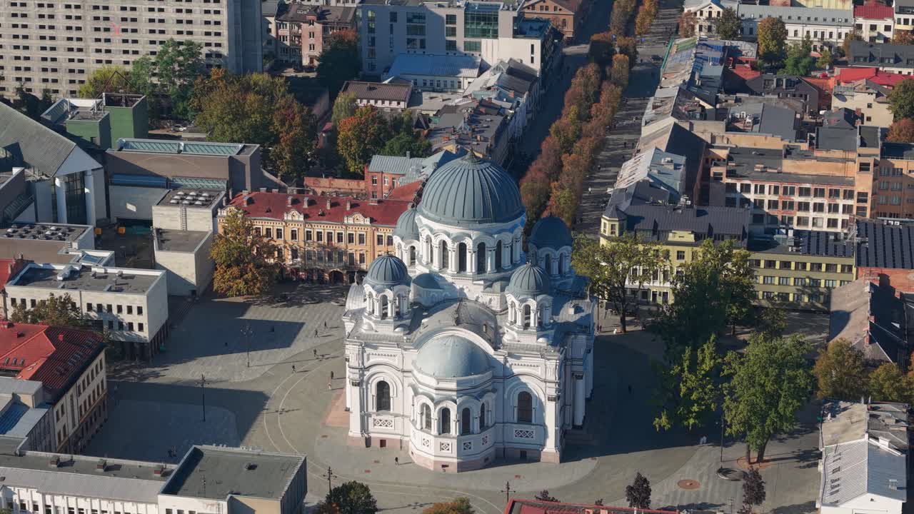 Aerial view of St. Michael the Archangel Church in Kaunas, Lithuania, surrounded by city buildings and tree-lined streets on a clear autumn day