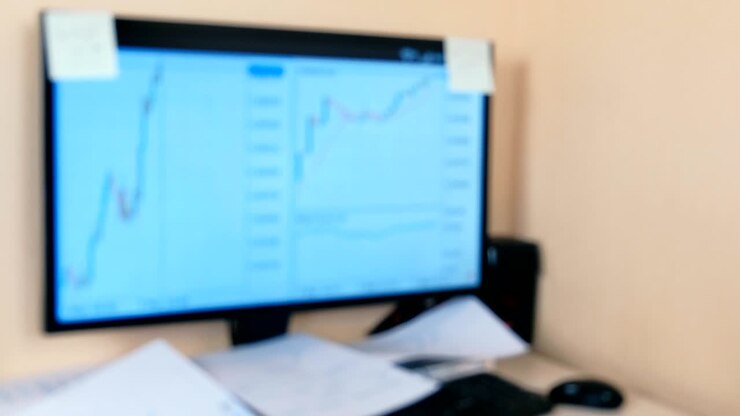 Screen with graphics on workplace. Blur.
