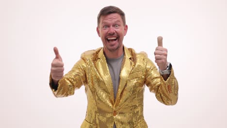 excited man in gold sequin jacket giving two thumbs up