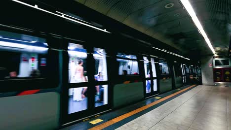 train approaches platform with passengers visible inside