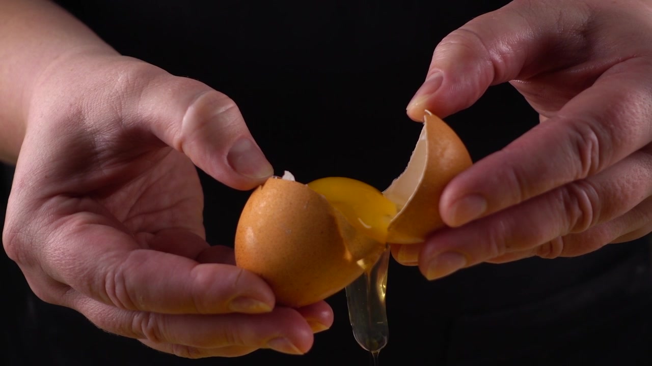 The cook reveals a broken raw egg.