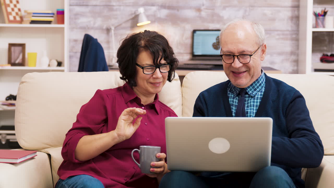 Senior Couple Enjoying Time at Home with Laptop