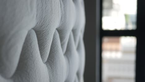 close-up of a white tufted headboard