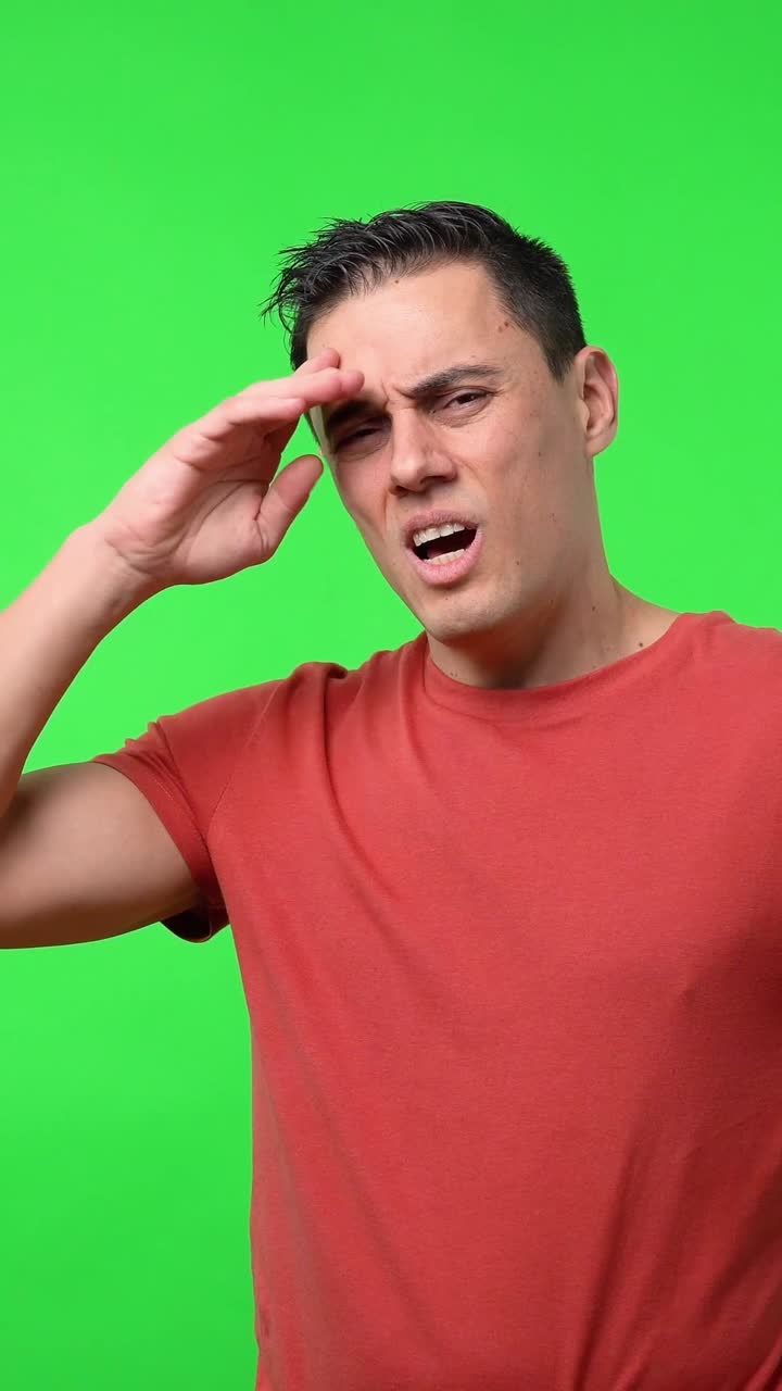 Man showing different expressions on green screen