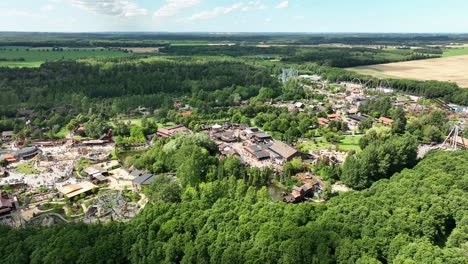 Aerial-parallax-over-Denmark's-famous-amusement-park-Djurs-Sommerland,-60fps