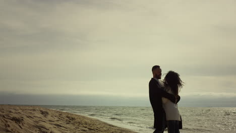 beautiful couple embracing beach at nature. boyfriend girlfriend hugging by sea.