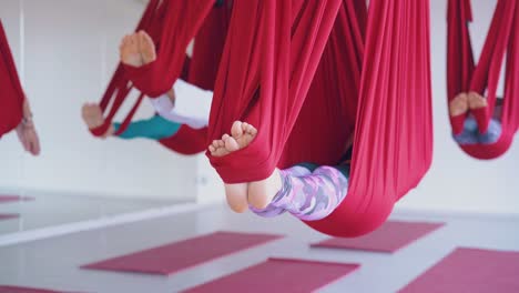 women feet swing in yoga hammocks relaxing after training