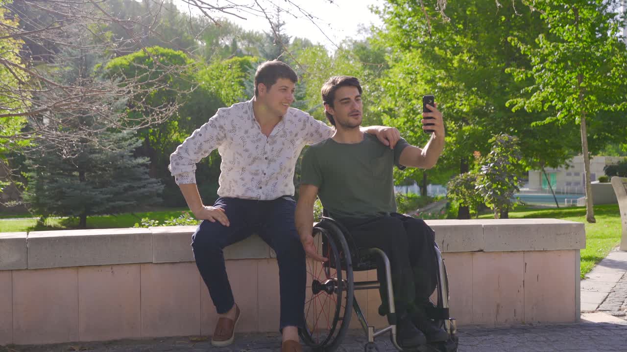 Disabled young man talking facetime on the phone.