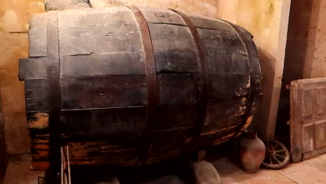 Old-historic-wooden-wine-barrel-in-cellar,-Aranda-de-Duero,-Burgos