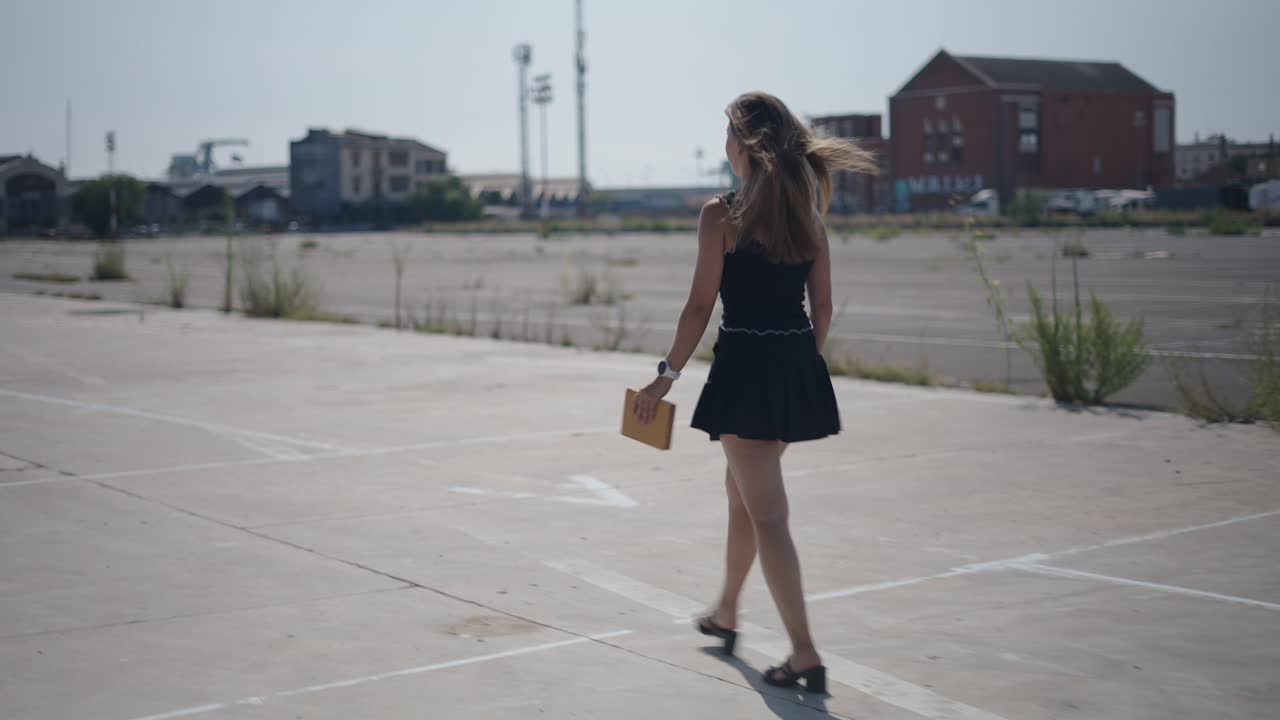 Woman Walking in a City Parking Lot