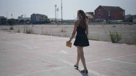 woman walking in a city parking lot
