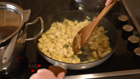 Frying-chicken-meat-in-a-pan,-preparing-lunch