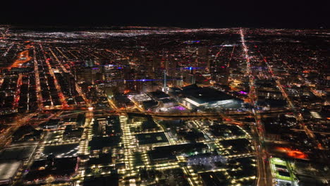 Denver-downtown-Colfax-i25-highway-traffic-aerial-drone-snowy-winter-evening-dark-night-city-lights-landscape-skyscraper-Colorado-cinematic-anamorphic-forward-down-motion