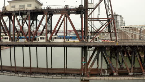 Profile-aerial-shot-of-a-Max-tram-over-Steel-Bridge-Portland-Oregon