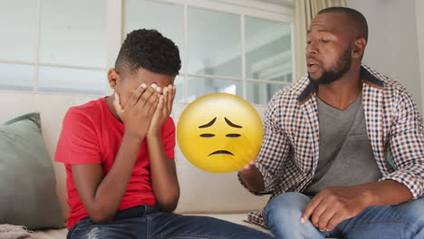 animation of sad emoji icon over african american father talking with son