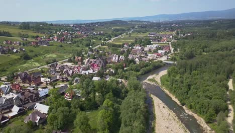 aerial view with tilt down of the zakopane area and river