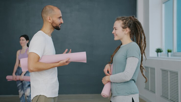 Yoga Instructor and Student Discussing