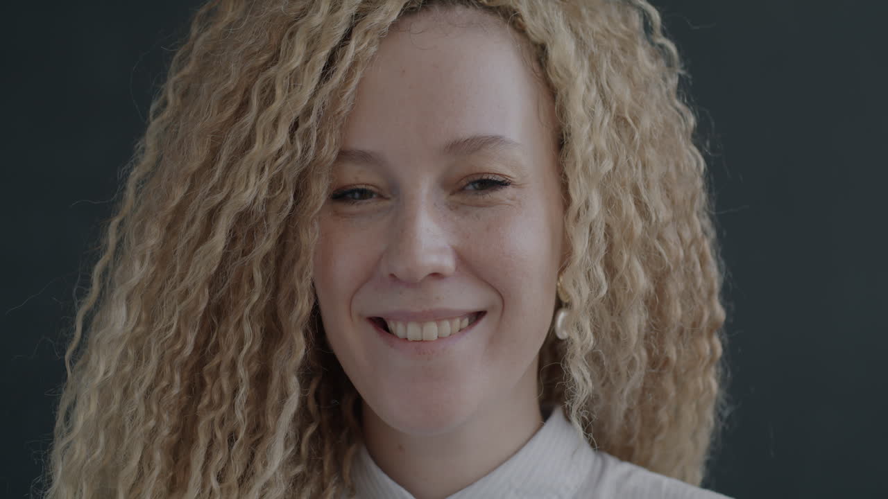 Smiling Woman with Curly Blonde Hair