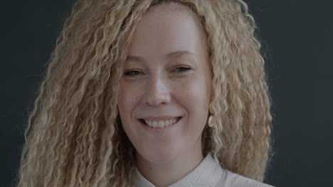 smiling woman with curly blonde hair