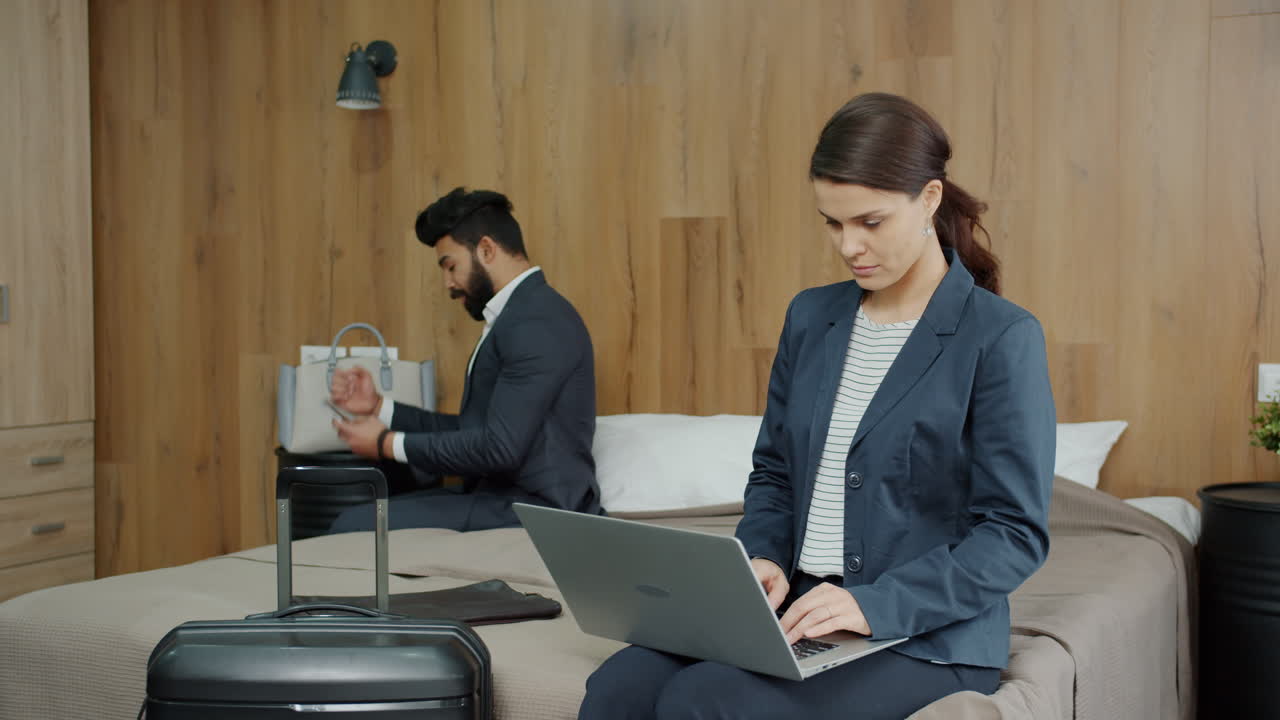 Business Couple Working in Hotel Room