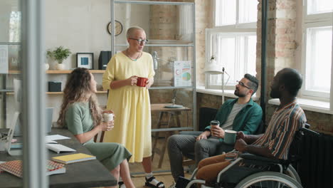 Diverse-Business-Team-Having-Coffee-and-Speaking-in-Office