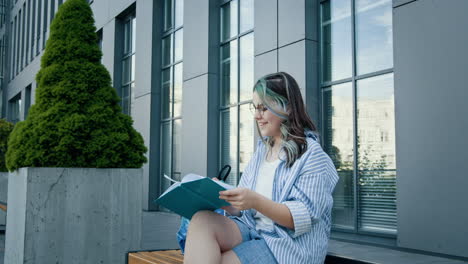 young woman reading outdoors