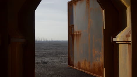 rusty door to a burnt landscape