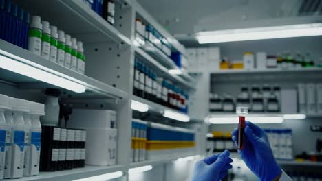 medical lab technician examining blood sample