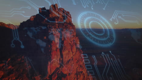 circuit board and digital interface animation over rocky mountain landscape