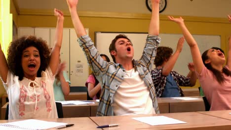 excited students cheering in classroom