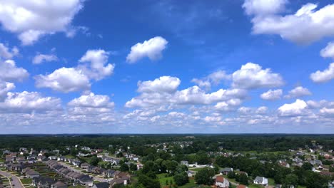 flying over houses on a beautiful sunny, cloudy day