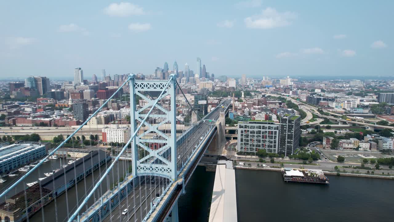 Ben Franklin Bridge rising drone shot to Philadelphia skyline summer morning